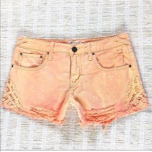 Free People distressed laced denim shorts in peach
